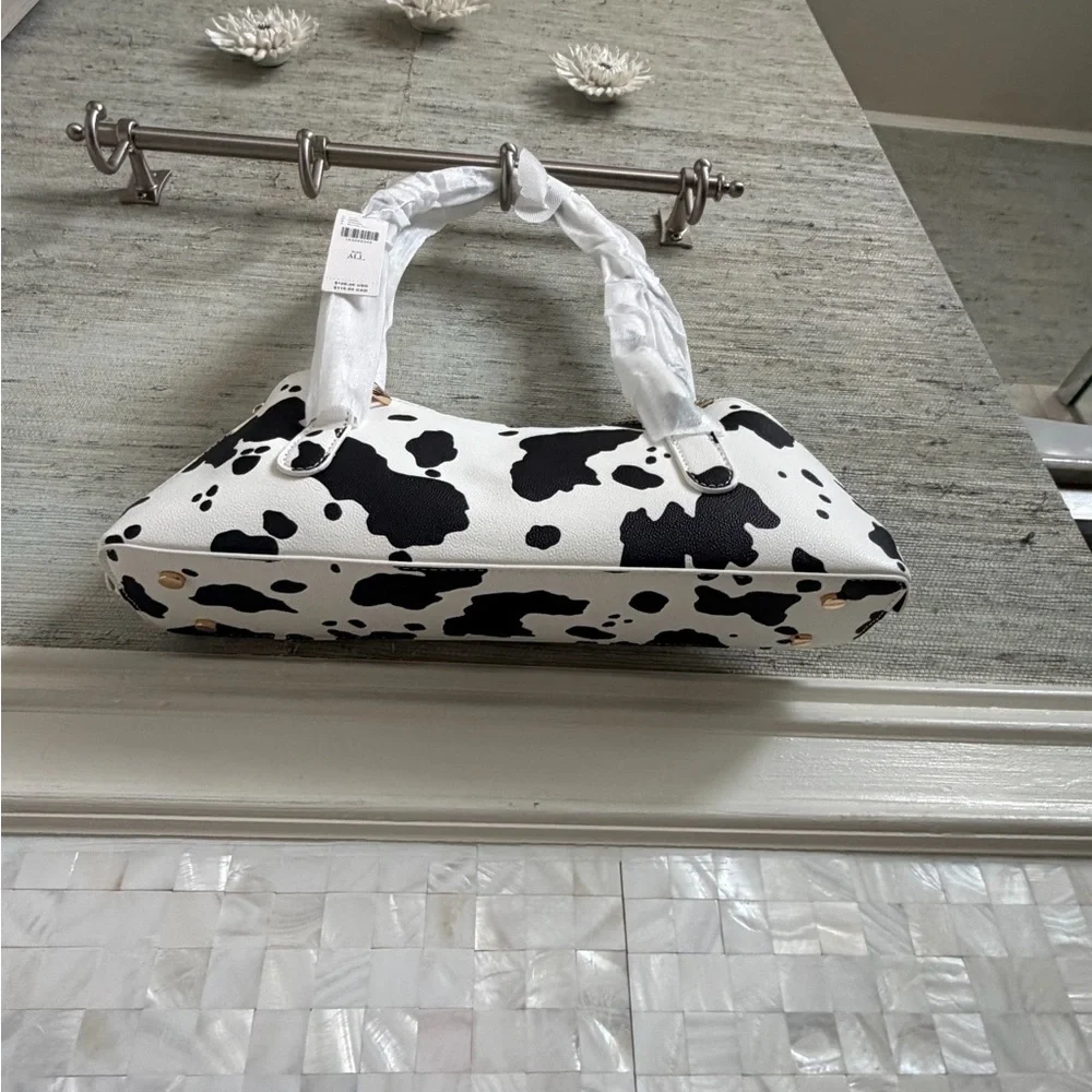 NWT new Anthropologie melie bianco east west shoulder bag cow print black white
